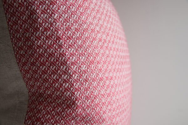 wool and cotton cushion in rose pink closeup detailing of handwoven design