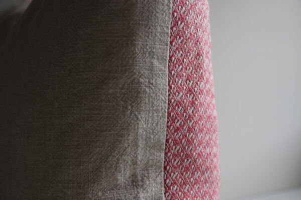 wool and cotton cushion in rose pink with natural stonewashed linen backing