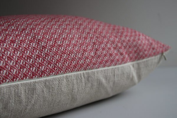 wool and cotton cushion in rose pink close up of YKK zip and hand woven design.