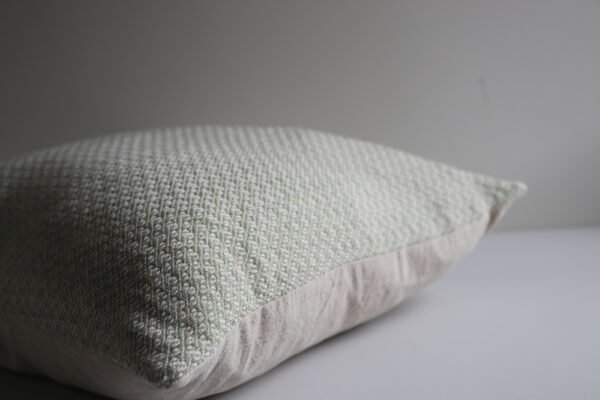 wool and cotton cushion in sage green showing linen back and pretty handwoven design