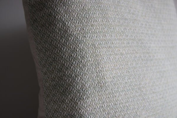 wool and cotton cushion in sage green closeup of pretty handwoven wool design